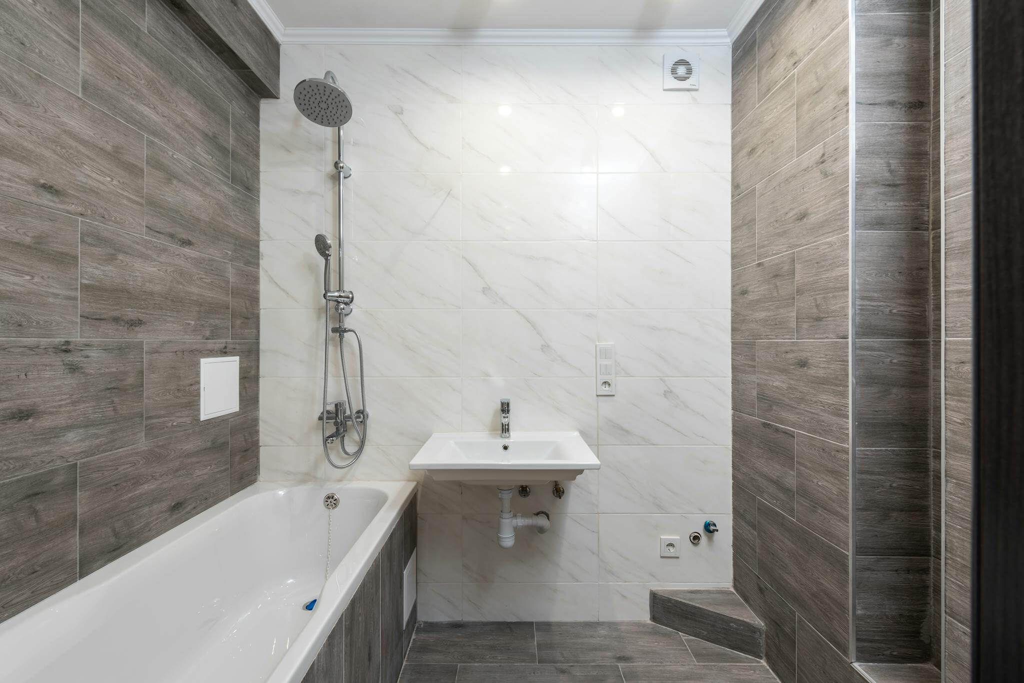 Elegant modern bathroom interior with wooden details and sleek design.